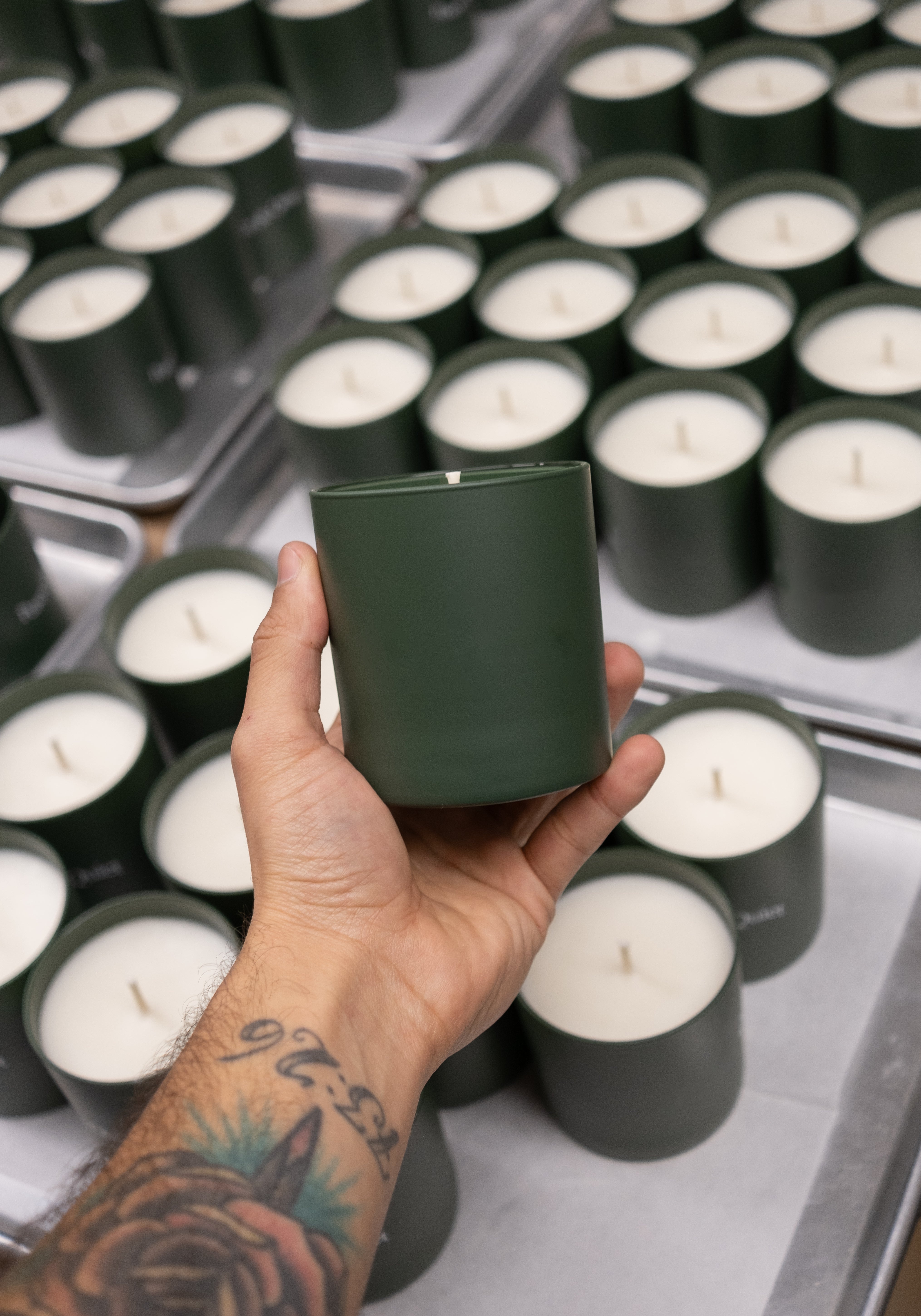 Candle in one hand and candles in the background